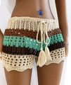 Close-up of crochet hollow-out texture with colorful stripes and tassel drawstring - Green