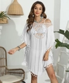 Close-up of white bohemian beach cover-up with intricate crochet lace neckline and tassels - One Size / White