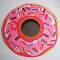 Overhead view of a round pink donut printed beach towel with colorful sprinkles pattern - Donut Print (st2200)