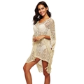 Macro shot of cream crochet beach cover-up showing hollow-out knit patterns and fringe - One Size / Apricot