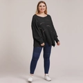 Detail view of black knit sweater with hollow out design and biker skinny jeans - Black