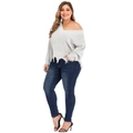 Close-up of the distressed V-neck grey knit sweater hem with ripped fringe detailing - L / White