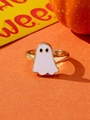 Detail of a minimalist gold Halloween ghost ring with white enamel on orange background - White Ghost Open Ring