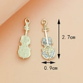 Golden violin-shaped metal pendant with white rhinestones and embossed wave pattern back - Violin KC Gold