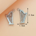 Silver metal harp charm pendants with intricate spiral patterns and sparkling crystals - Harp Silver