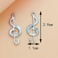 Silver treble clef music charms with rhinestones on orange background, 2.9cm tall - Treble Clef Silver