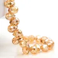 Macro shot of 4-8mm faceted K9 crystal glass teardrop beads in a polished amber gold finish - Amber Gold / 6mm (approximately 87 Beads Per Strip)
