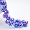 Macro shot showing detail of dark blue faceted teardrop crystal beads with sparkle - Medium Blue AB / 6mm (approximately 87 Beads Per Strip)