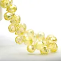 Macro detail of yellow faceted K9 crystal teardrop beads with brilliant cut surfaces - 8mm (Approx 87 beads/string) / Light Yellow AB