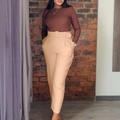 Women's high-waisted khaki dress pants with a matching buckled belt and pleated front - Khaki