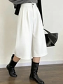 Détail d'un pantalon court blanc à jambes larges avec taille haute et bouton noir discret - S / Blanc