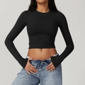 Close-up of slim fit black long sleeve crop top for yoga and fitness training - Premium Black