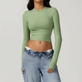 Detail of a grass green tight long sleeve yoga top with premium elastic knitted fabric - Grass Green