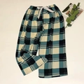 Close-up of green plaid pajama pants with elastic waistband and white satin bow detail - Blue Plaid