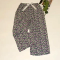 Detail of floral wide-leg sleep pants with purple print and a white ribbon bow tie - Purple Small Floral