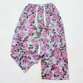 Close-up of floral print pajamas pants with elastic waistband and decorative drawstring - Red Flowers Green Leaves
