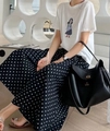 Close-up of white graphic t-shirt and black polka dot maxi skirt with black leather tote bag - One Size / Black Polka Dot