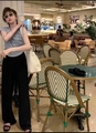 Relaxed fit high-waisted black wide-leg trousers styled in a casual cafe setting - Black