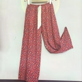Detail of red floral cotton lounge pants with elastic waist and white satin ribbon tie - Red Small Floral