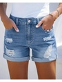 Detail showing distressed holes and vintage wash on blue denim shorts for women - S / Bottoms / Light Blue