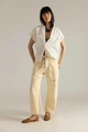 Detail view of cream straight-leg pants featuring drawstring waist and distressed knee rips - S / Cream Yellow Distressed (14652G)