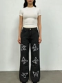 Detail of high-waisted dark grey wide-leg jeans featuring unique artistic butterfly prints - S / Black