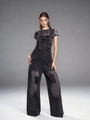 Macro shot of distressed charcoal grey denim texture with ripped fringes on overalls - S / Black