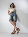 Detail view of high waist denim shorts with side cargo pockets in a light blue wash - S / Light Blue