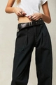 Detail of high-waist black wide-leg trousers with a vintage leather belt and silver buckle - S / Black