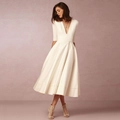 Detailed view of elegant ivory satin dress with deep V-neck and pleated A-line skirt - S / White