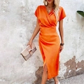 Bright orange satin V-neck dress with pleated waist and side slit shown on a model outdoors - Orange Red