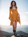 Detail of deep V-neck and flared sleeves on a vibrant orange asymmetrical dress - Earthy Yellow