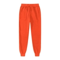Dettaglio dei pantaloni sportivi arancioni con coulisse in vita e polsini a costine - S / Rosso Arancio