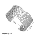 Detail view of wide stainless steel cuff with hammered texture and precise dimensions - Steel