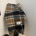 Close-up of retro plaid scarf with long fringes and woven logo brand tag - Black Brown