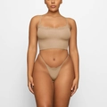 Detailed view of nude two-piece lingerie set with delicate lace trim on seamless fabric - S / Khaki