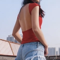 Slim fit red backless short sleeve top paired with distressed denim shorts outdoors - S / Red