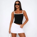 Detail of a black cropped tank top with white piping and a matching white mini skirt - S / White