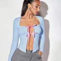 Detail of light blue long sleeve top with pink ribbon bows and square neckline design - S / Blue