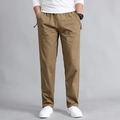 Men's khaki cotton cargo pants featuring elastic waist and decorative side drawstrings - M / Khaki