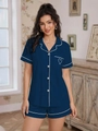Detail view of navy blue pajama shirt pocket with white embroidered heart and contrast piping - S / Navy Blue