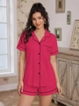 Detail of rose pink short sleeve pajama set featuring black piping and heart pocket embroidery - Rose Red