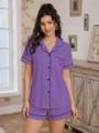 Detail of lavender pajama set featuring black contrast piping and heart embroidery - Purple