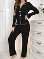 Detail of black ribbed loungewear set featuring white contrast trim and bow accents - S / Top And Bottom / Black