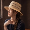 Women's beige straw sun hat with open-weave detail and flat top worn by a model - Khaki (D-0003)