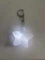 Macro shot of glowing star keychain with white LED light and silver metal D-ring buckle - White Five-pointed Star Pendant Keychain
