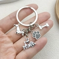 Silver dog memorial keychain with dachshund, bone, and paw pendants held in hand - Dachshund Dog Style (LS66)