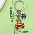 Pet keychain with Corgi driving red car, black paw print, and white bone charms - Driving Dog Paw Bone Heart Style (ER420)