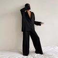 Detail of elegant black satin pajama set with button-down shirt and wide-leg trousers - S / Top And Bottom / Black