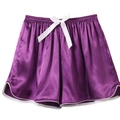 Detail of purple satin sleep shorts featuring a white silk bow and contrast piping edges - Purple
